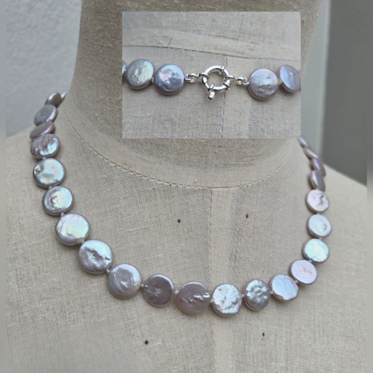 Pearl necklace on a mannequin with a neutral background