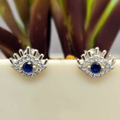 A pair of sterling silver stud earrings with a cubic zirconia evil eye design.