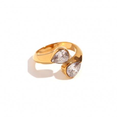 Gold ring with two clear gemstones on a white background