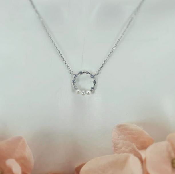Sterling silver necklace with circle detail in cubic zirconia and freshwater pearls