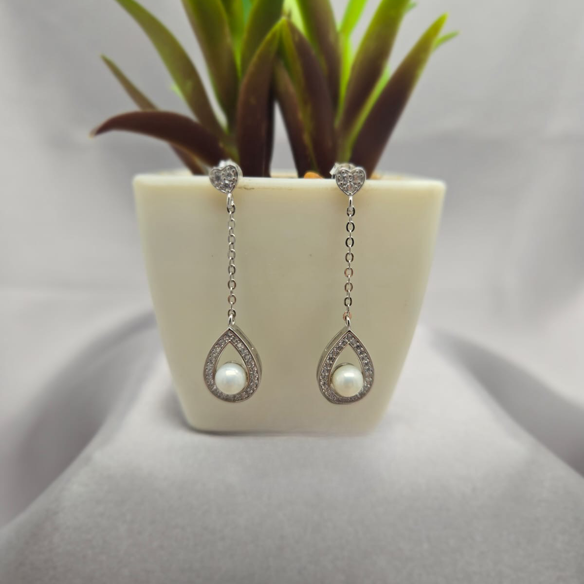 Sterling silver drop earrings with pearl and cubic zirconia detail