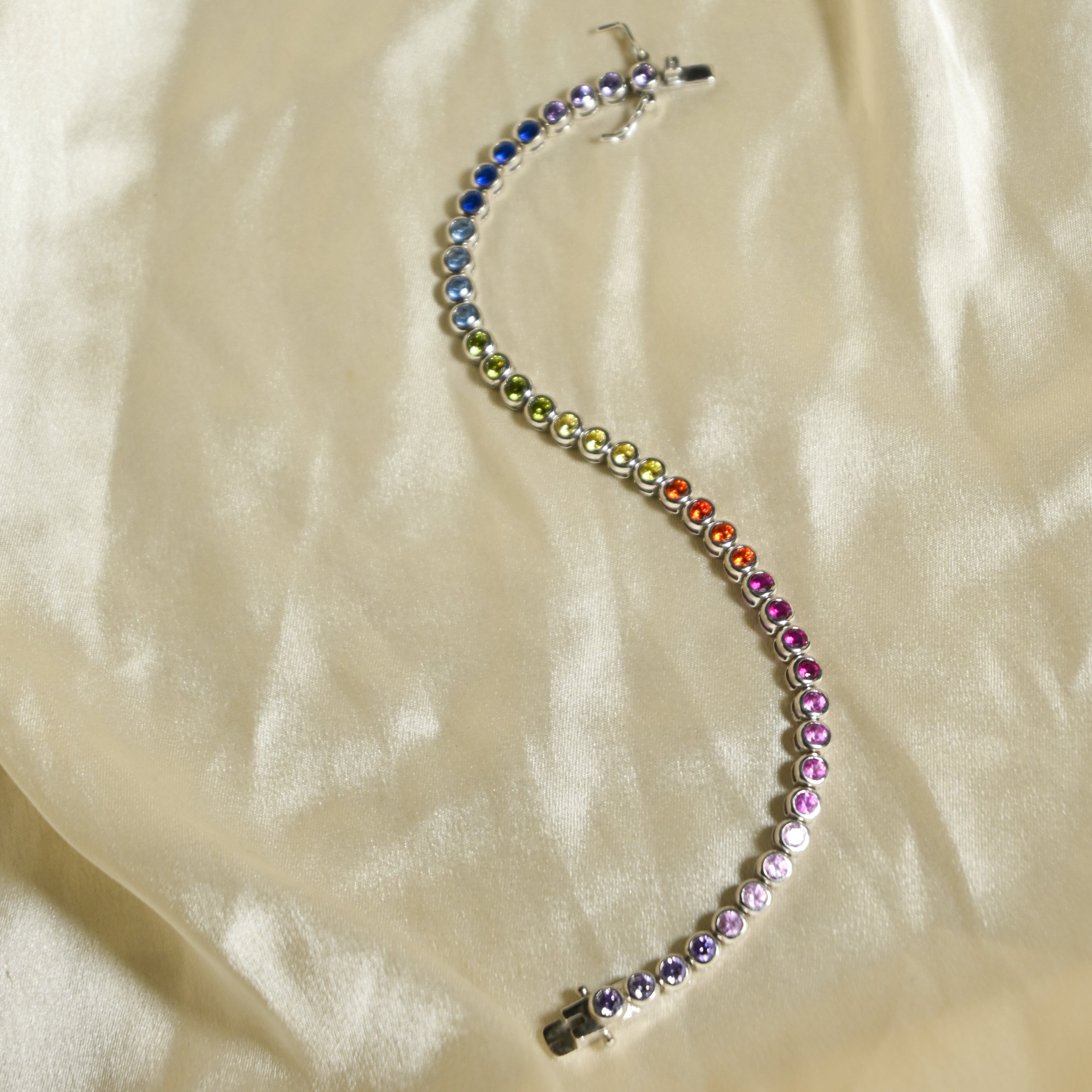 Multicolored beaded bracelet on a beige fabric background