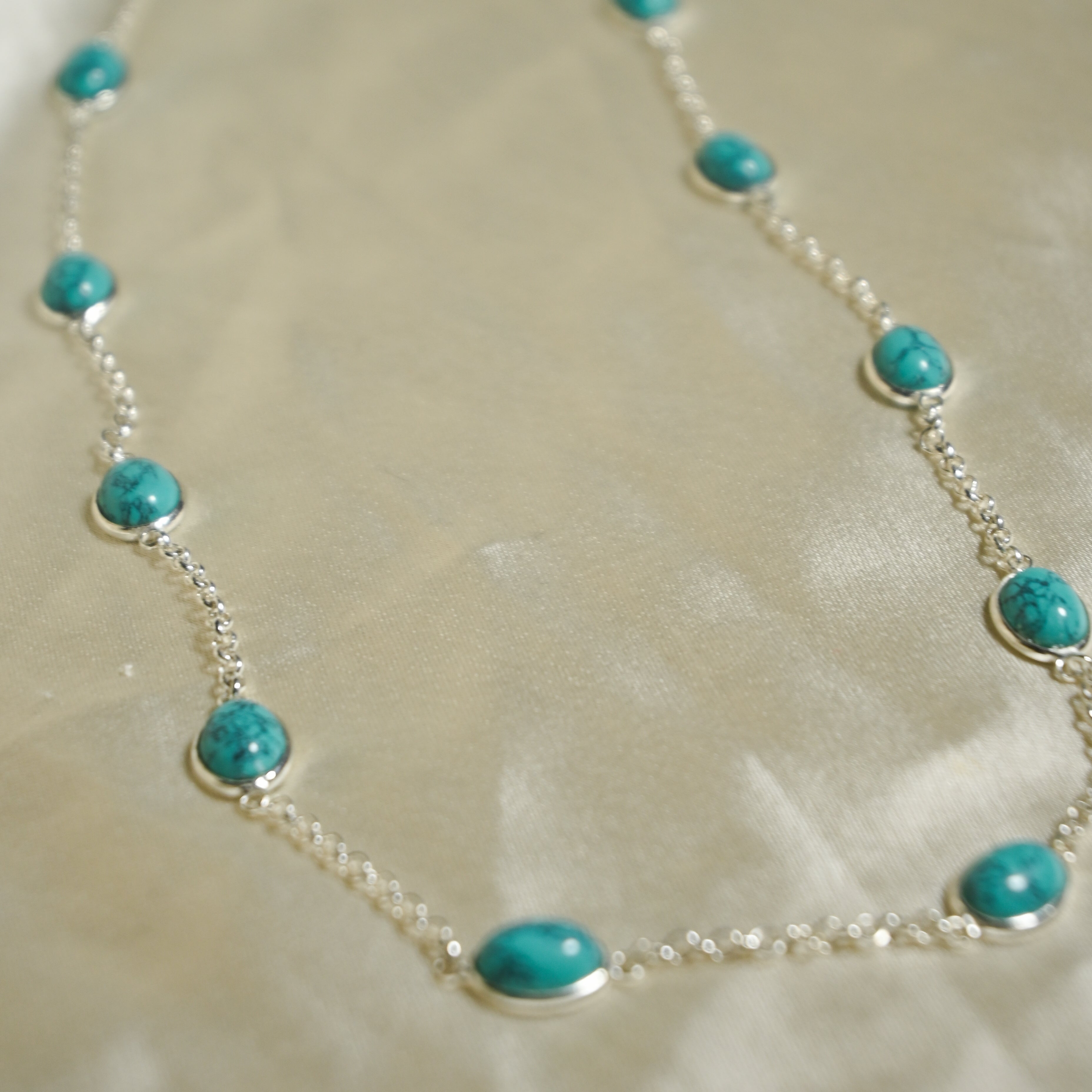Necklace with turquoise beads on a beige background