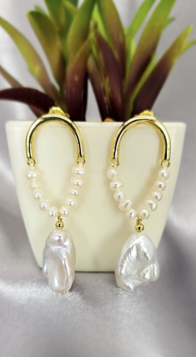 Gold statement earrings with beautiful pearls on end