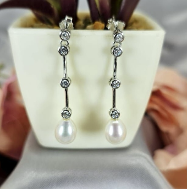 Long drop earrings with cubic zirconia detail and stunning freshwater pearl on end