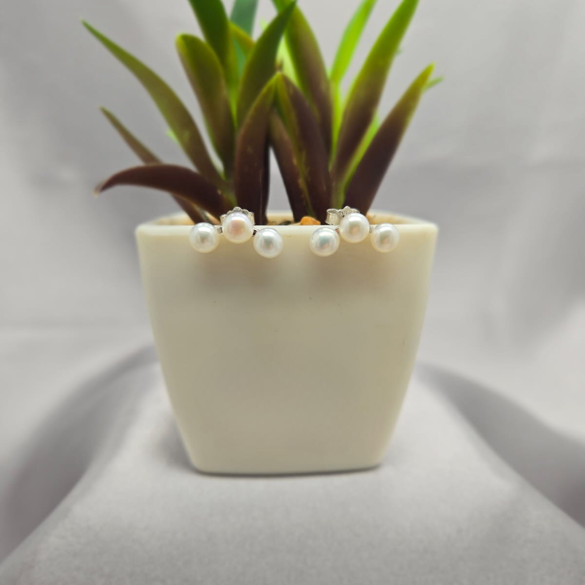 Three pearl ear shaped stud earrings