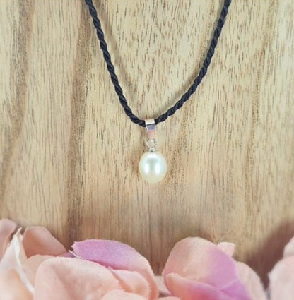 Black silk cord with freshwater pearl pendant on it