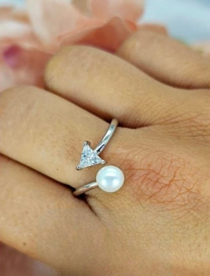 Adjustable sterling silver ring with freshwater pearl on one side and cubic zirconia arrow point on other side