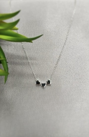 Three flat hearts on necklace