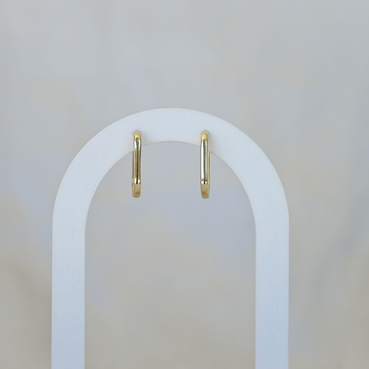 Gold paperclip shaped huggy earrings