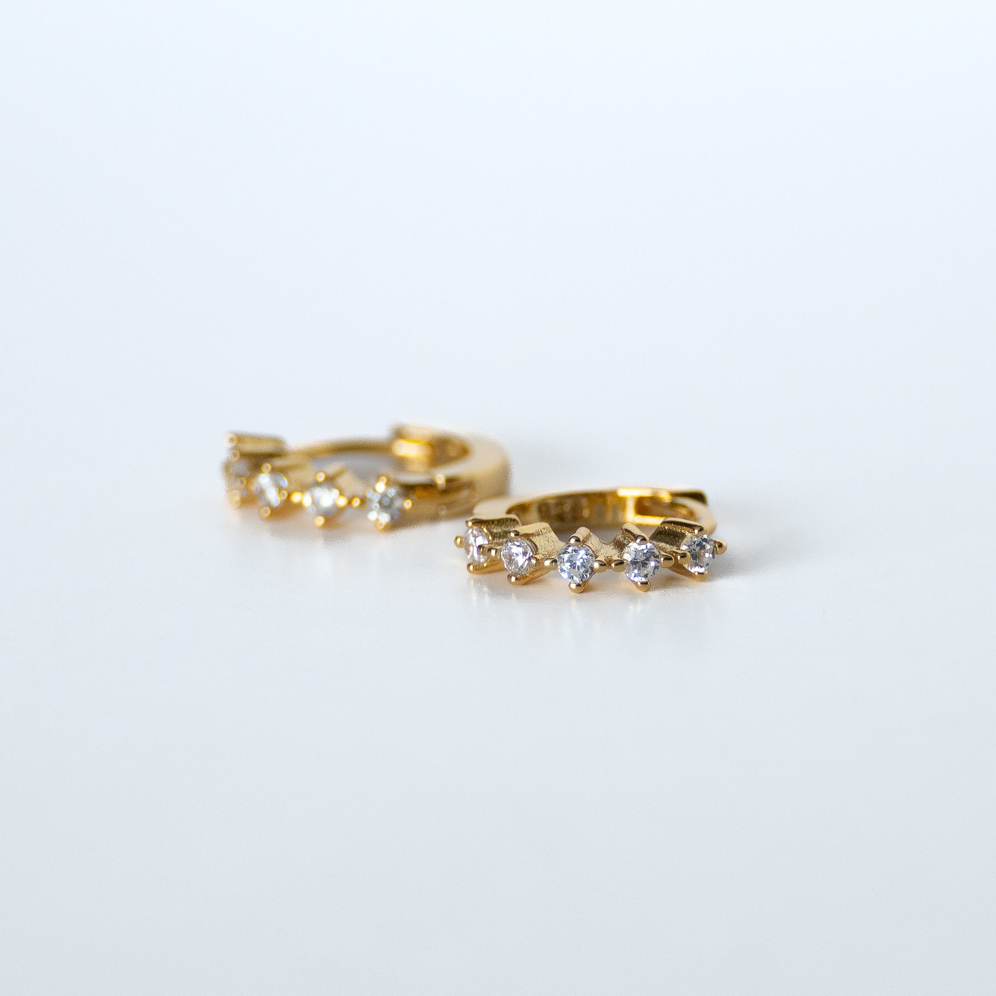 Golden Huggy Earrings With Diamond Shaped Cubic Zirconia
