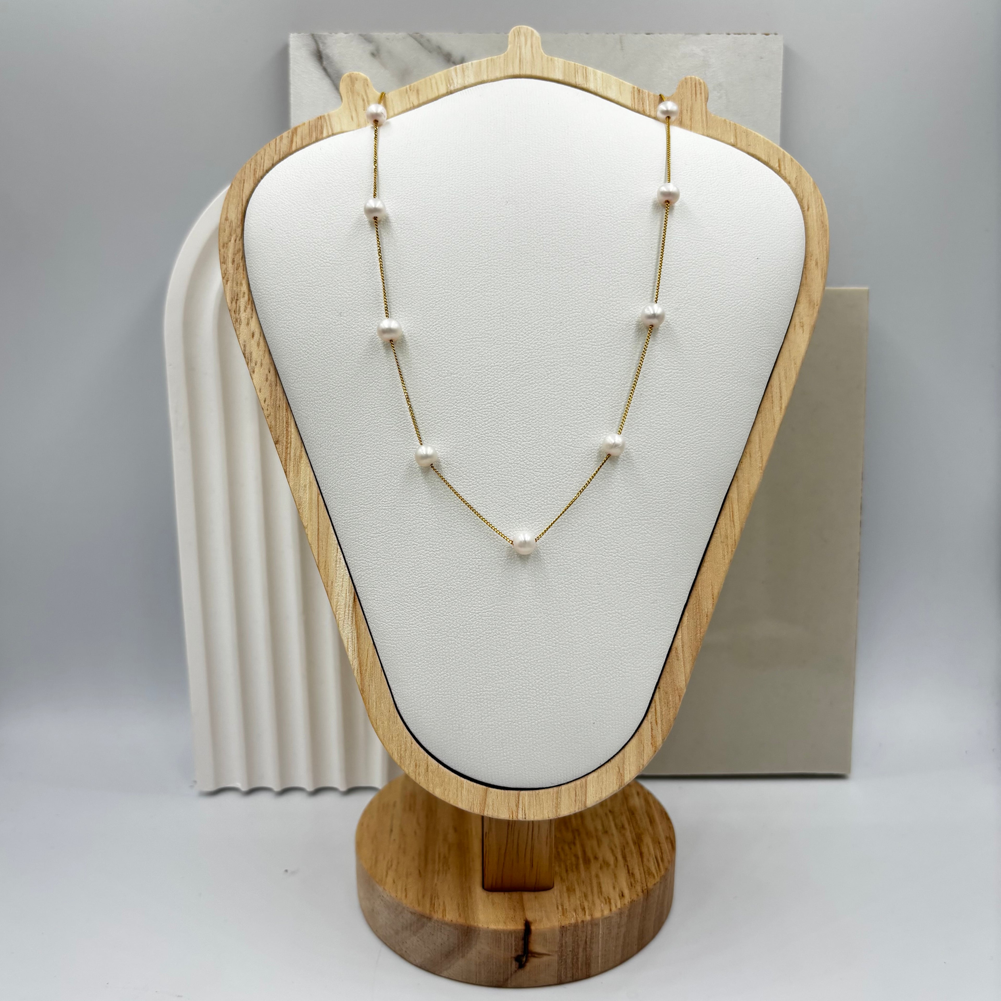 Nine freshwater pearls on gold chain