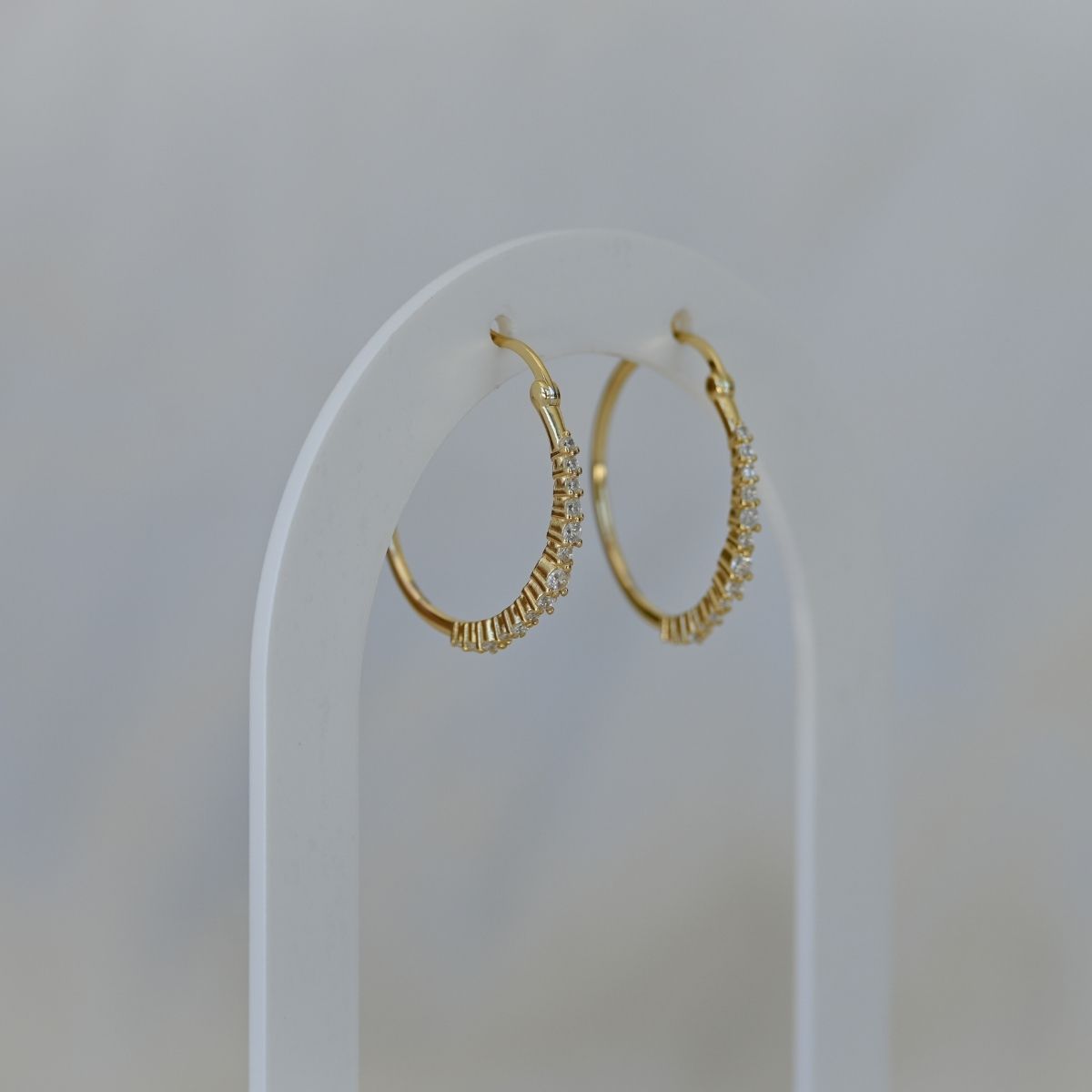 Gold hoop earrings with clear zirconia stones