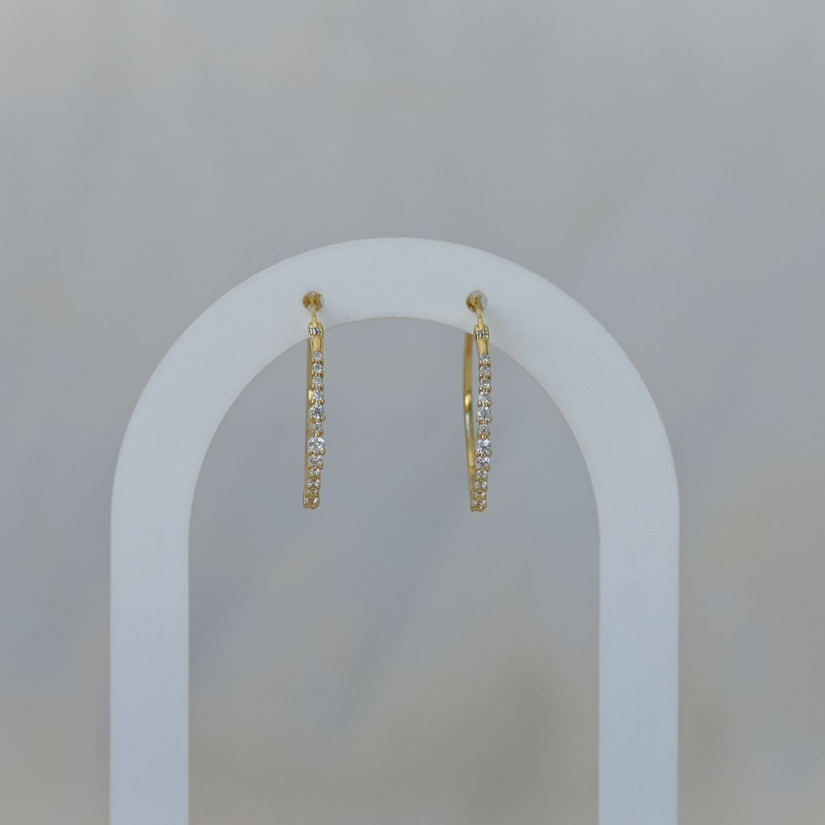 Gold hoop earrings with clear zirconia stones
