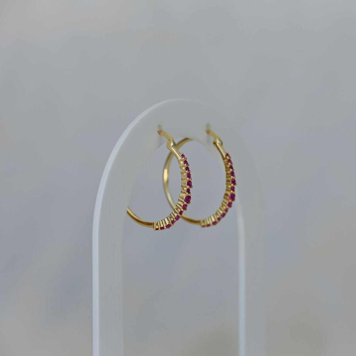 Gold hoops with ruby zirconia stones