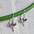 Silver dragonfly earrings on a green stick with a light gray background