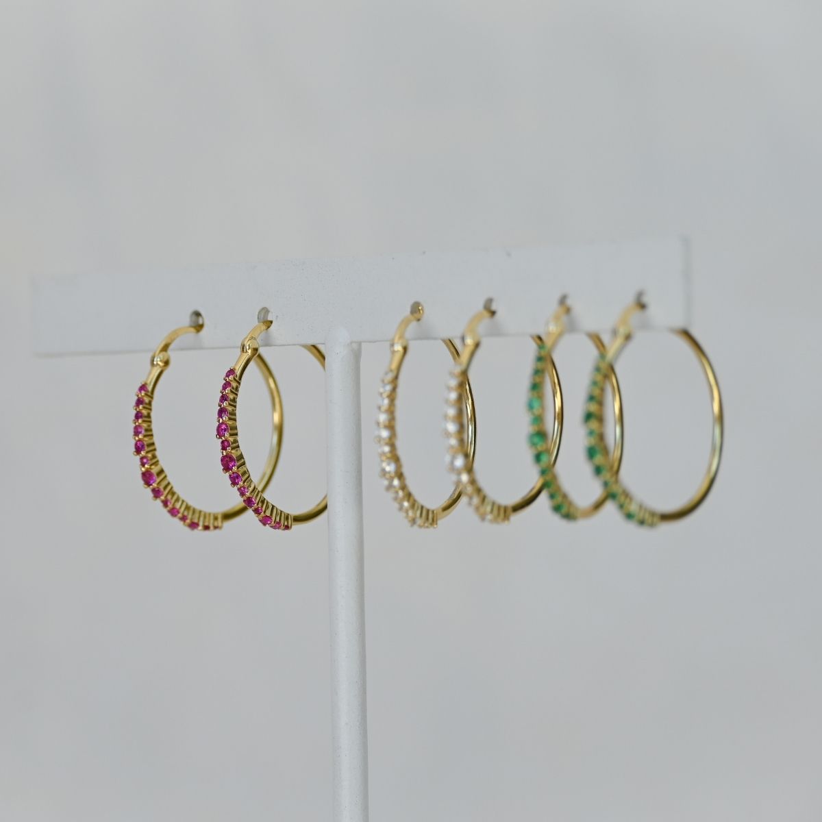 Gold hoops with ruby zirconia stones