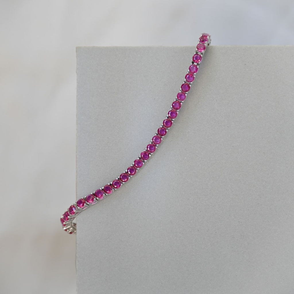 Pink gemstone bracelet on a light gray background