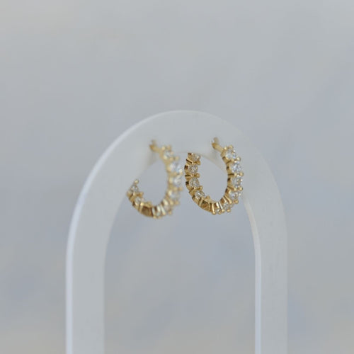 Gold huggy earrings with clear zirconia stones