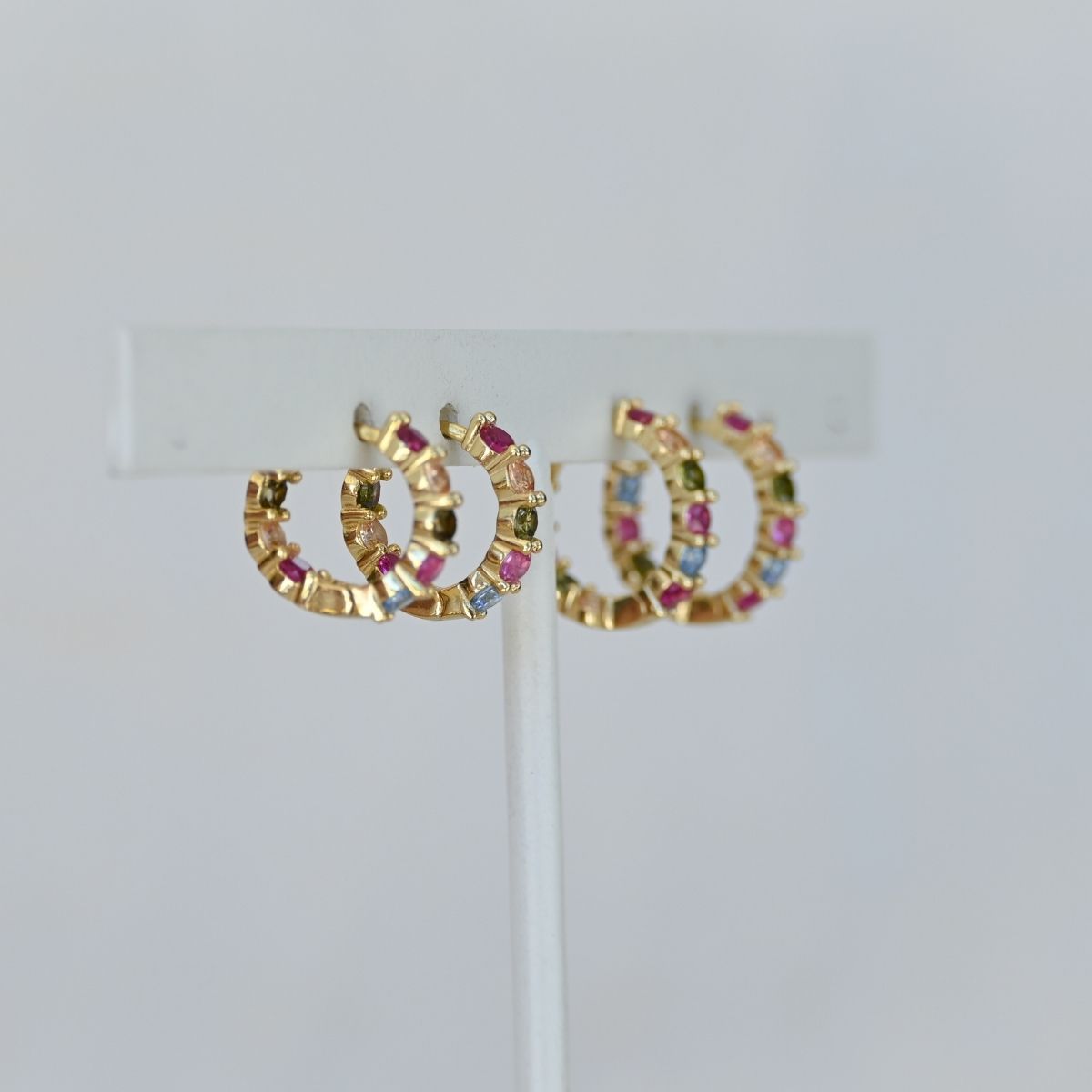 Five coloured zirconia gold huggy earrings