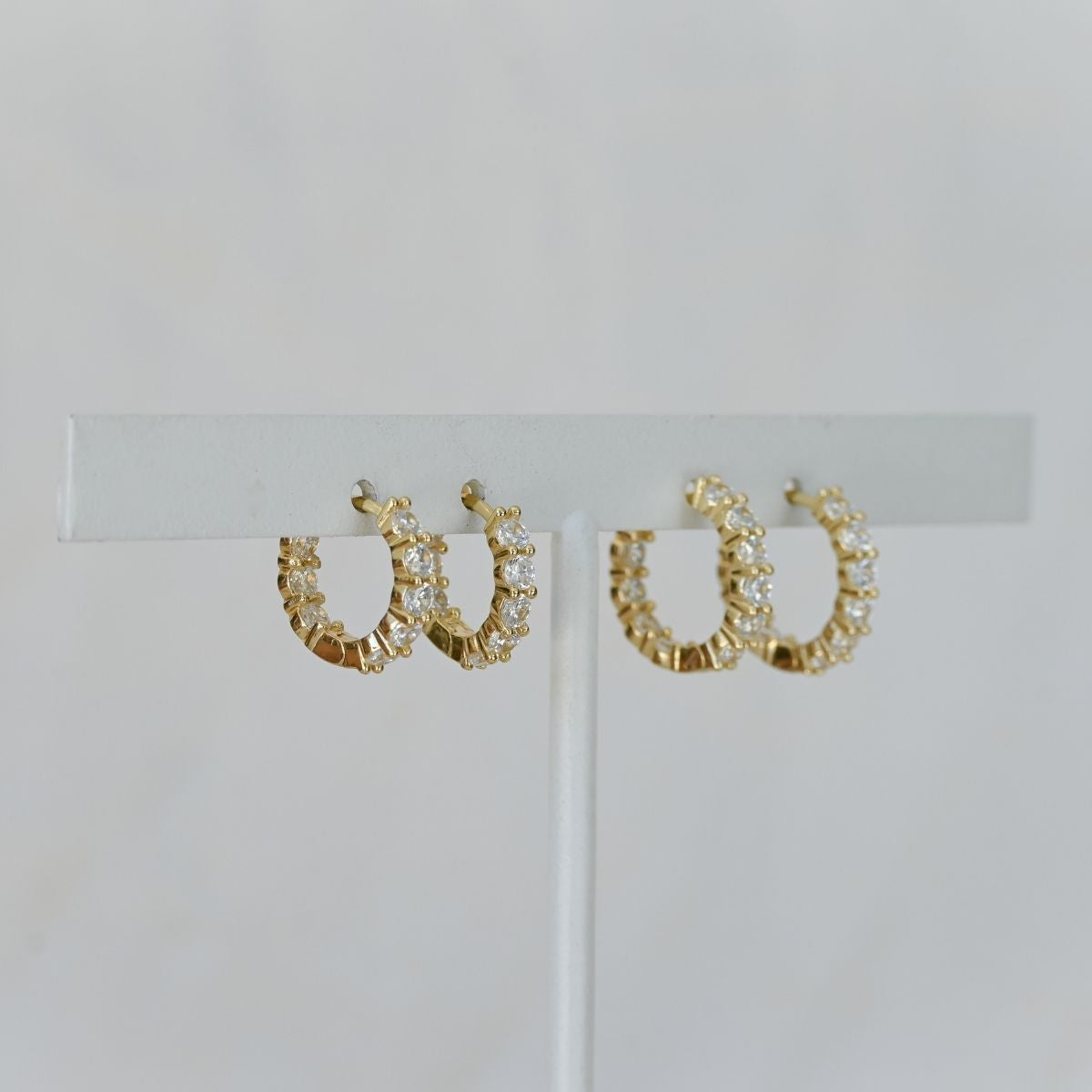 Gold huggy earrings with clear zirconia stones
