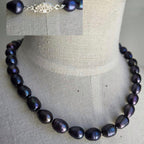 Necklace with dark pearls on a mannequin bust against a neutral background