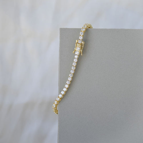 Gold tennis bracelet with clear zirconia stones