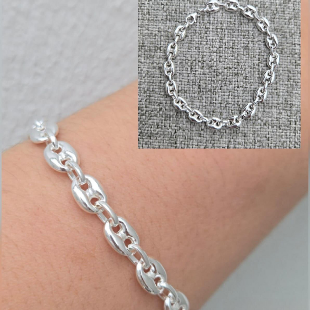Silver chain bracelet on a wrist with close-up inset