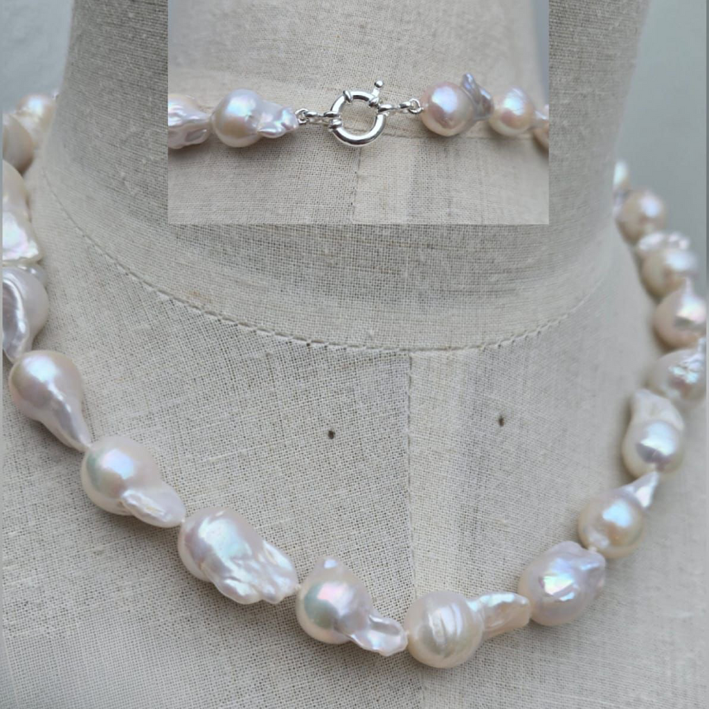 Pearl necklace on a mannequin with close-up inset of clasp.
