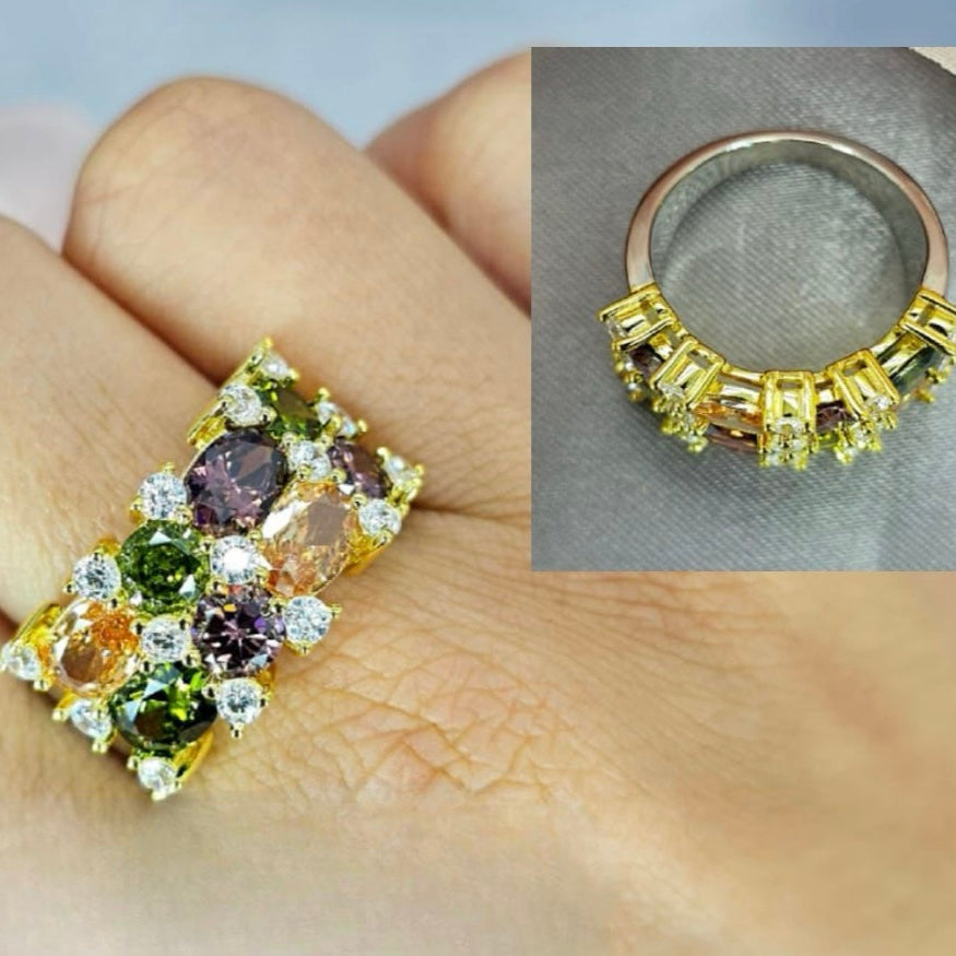 A gold-plated sterling silver ring with cubic zirconia stones and multicolored gemstones.