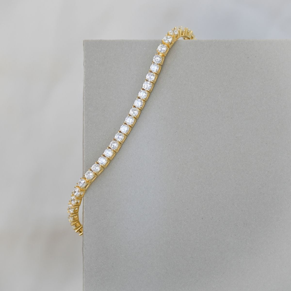 Gold tennis bracelet with clear zirconia stones
