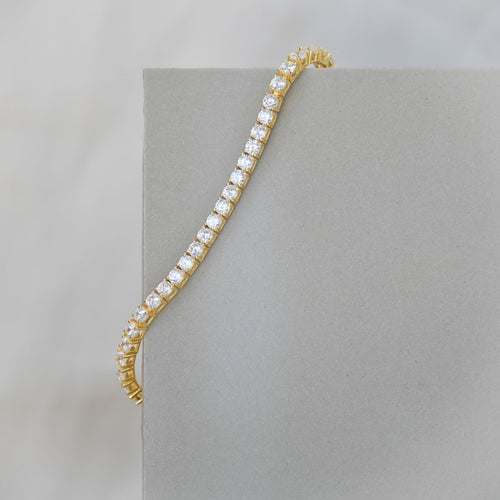 Gold tennis bracelet with clear zirconia stones