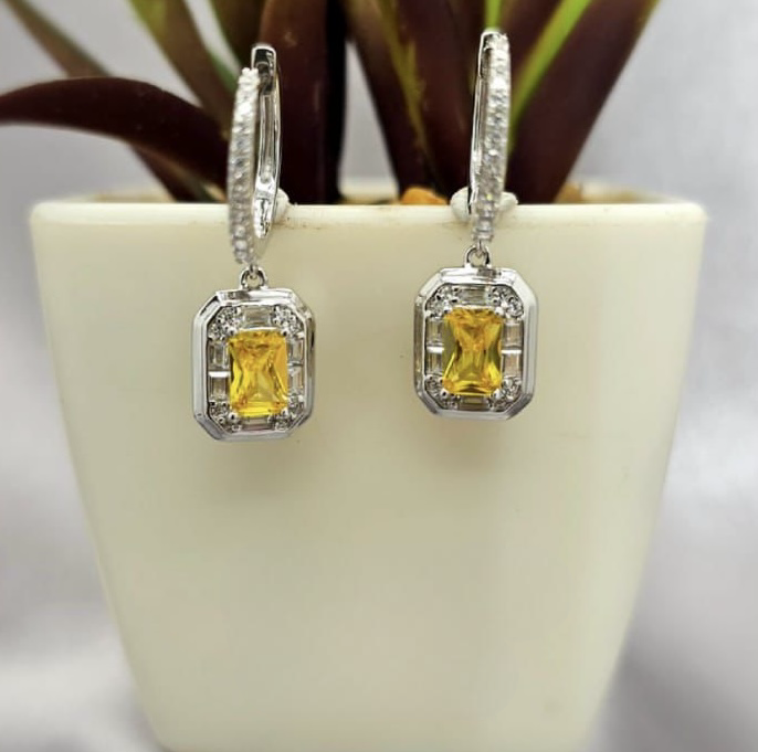 Cubic zirconia pavé Huggy earrings with gold/yellow stone dangling