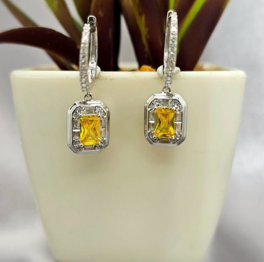 Cubic zirconia pavé Huggy earrings with gold/yellow stone dangling