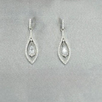 A pair of silver drop earrings with cubic zirconia, displayed against a neutral background with a floral motif.