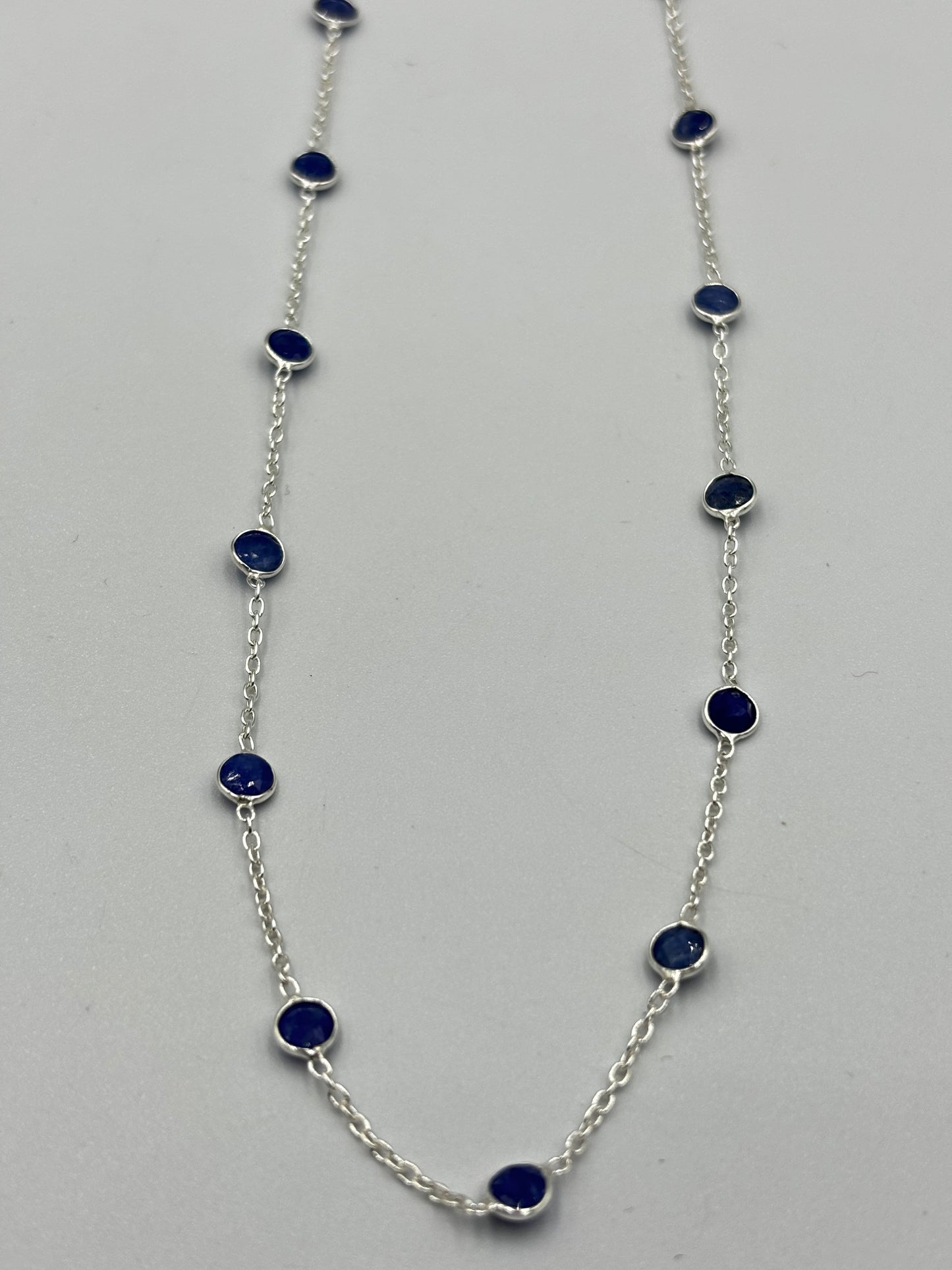 Sterling silver necklace with blue 5mm sapphire semi precious stones in-bedded in necklace