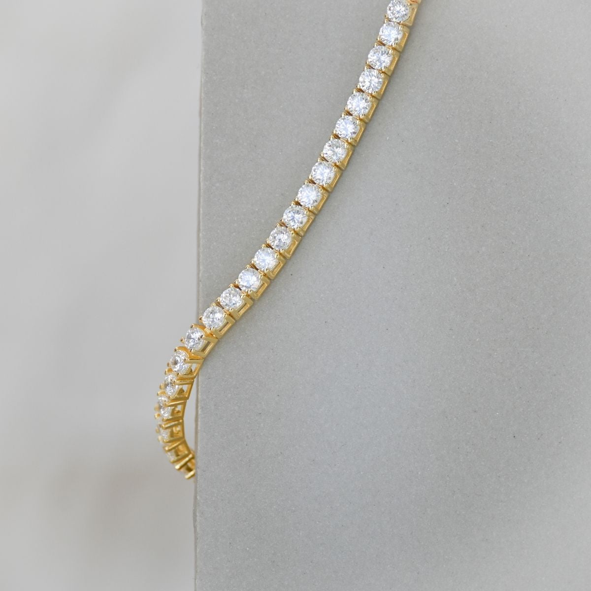 Gold tennis bracelet with clear zirconia stones
