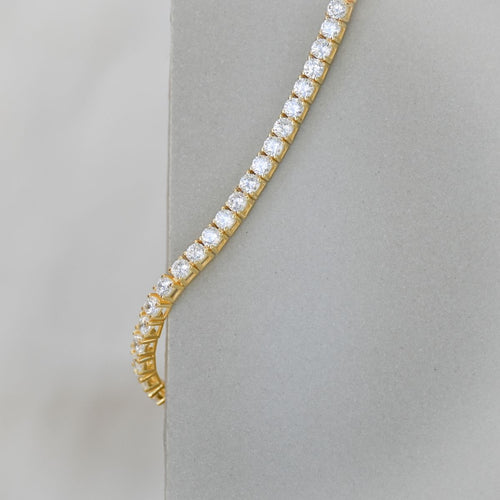 Gold tennis bracelet with clear zirconia stones
