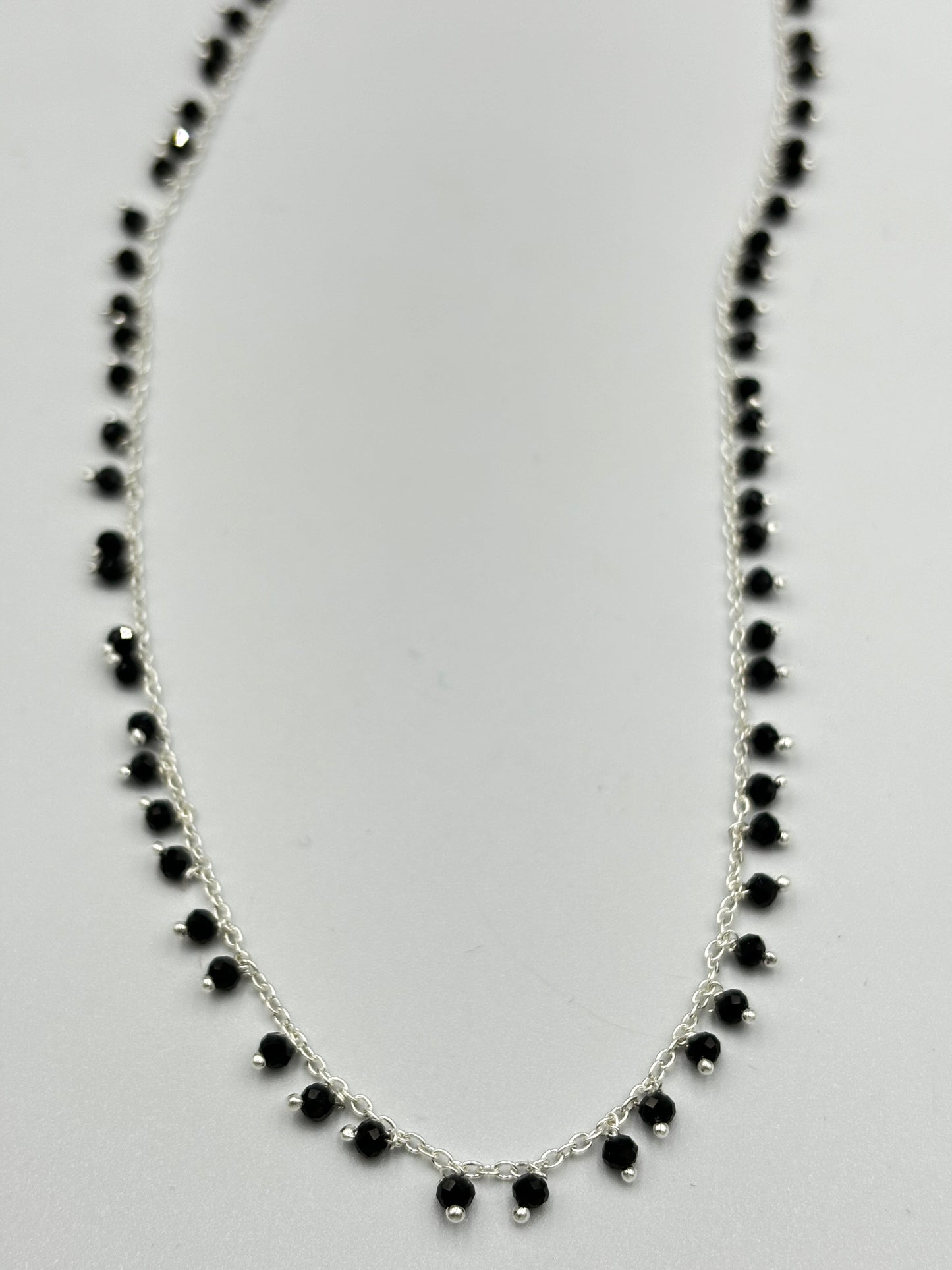 Sterling silver necklace with lots of dangling black spinal semi precious stones