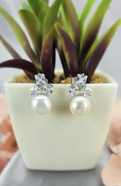 Freshwater pearl earrings with cubic zirconia trio on top