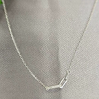 A sterling silver necklace with Gucci links displayed on a gray background.