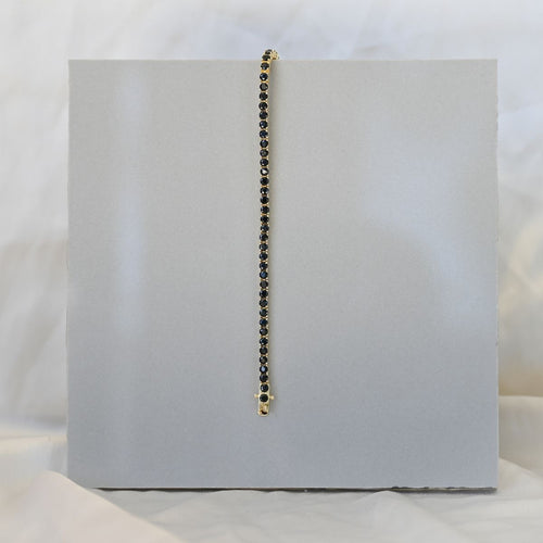 Gold tennis bracelet with black zirconia stones