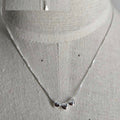 Silver necklace with heart pendants on a mannequin
