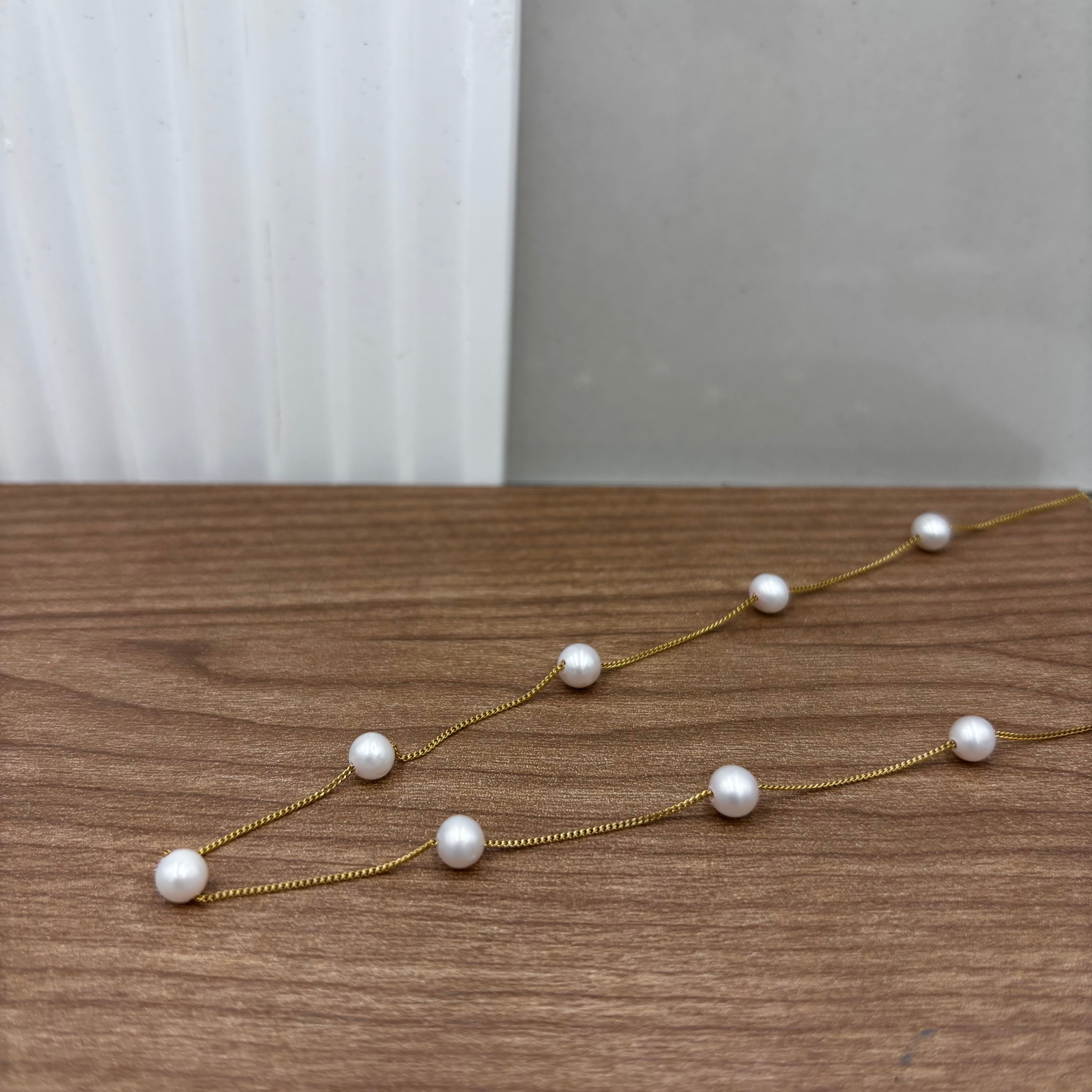 Nine freshwater pearls on gold chain