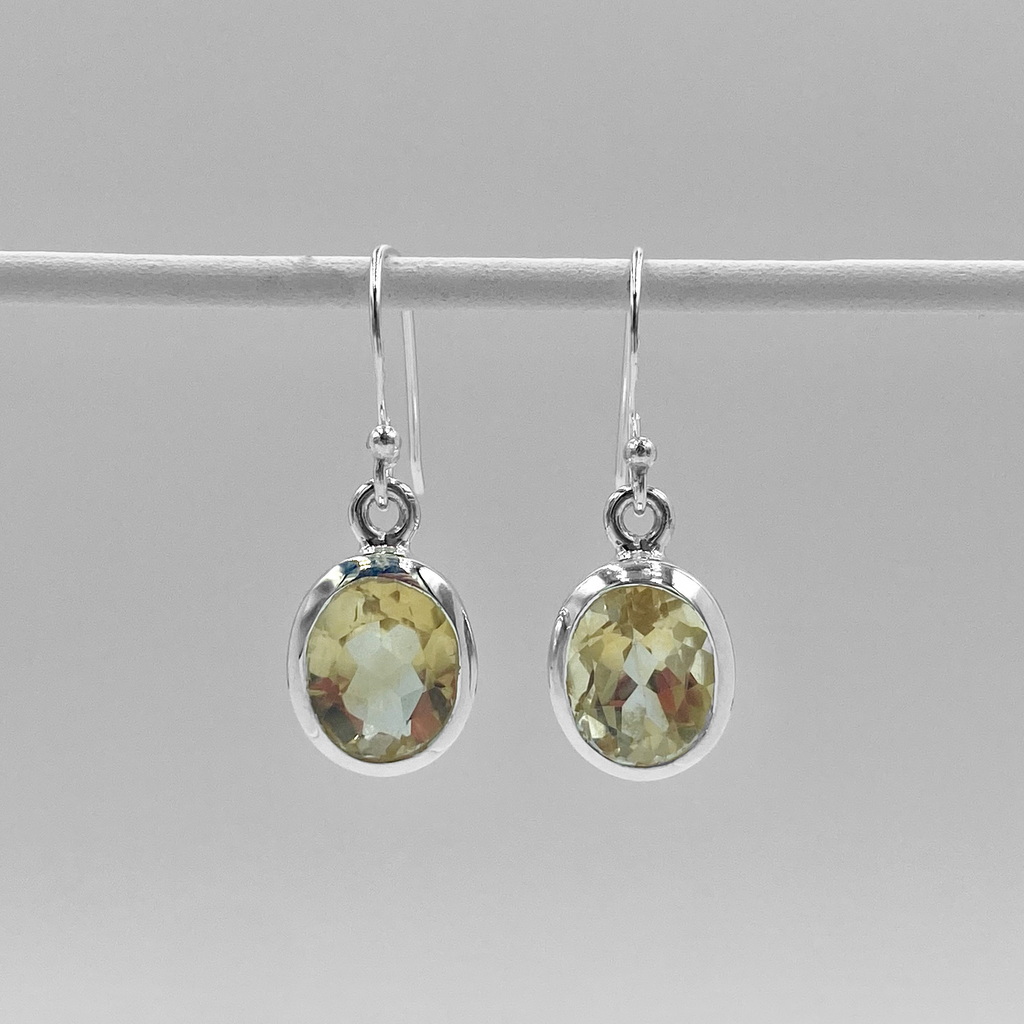 A pair of sterling silver oval drop earrings with vibrant citrine semi-precious stones.