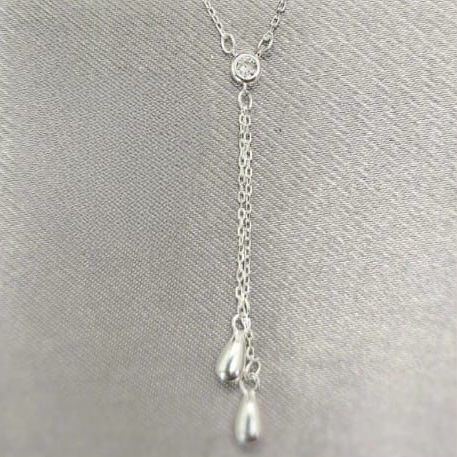 A sterling silver drop necklace with sparkling cubic zirconia, displayed on a grey background.
