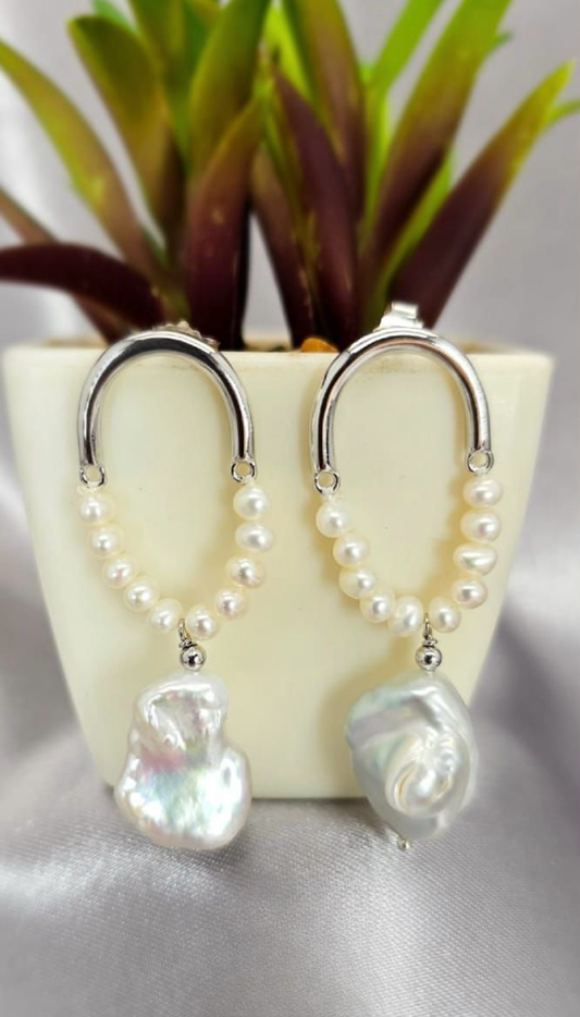 Silver statement earrings with beautiful freshwater pearls on end