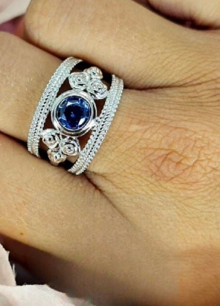 Sterling silver flower filigree detail ring with blue cubic zirconia centre
