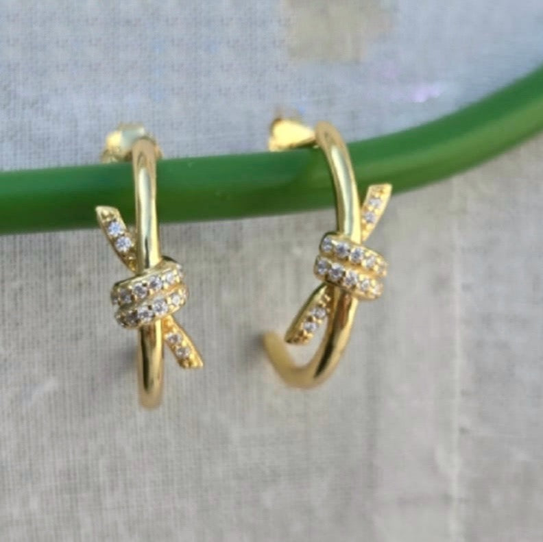 Golden bow hoop earrings with spots of bling