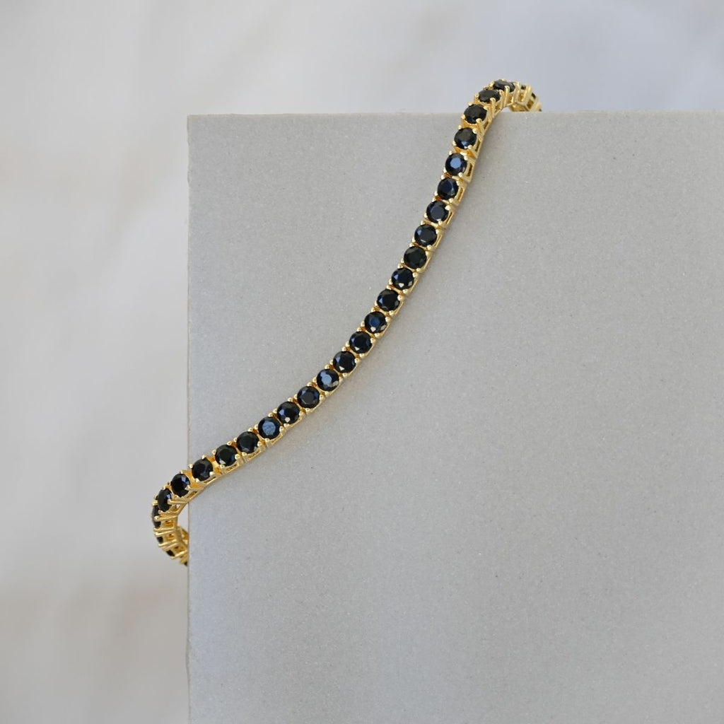 Gold tennis bracelet with black zirconia stones